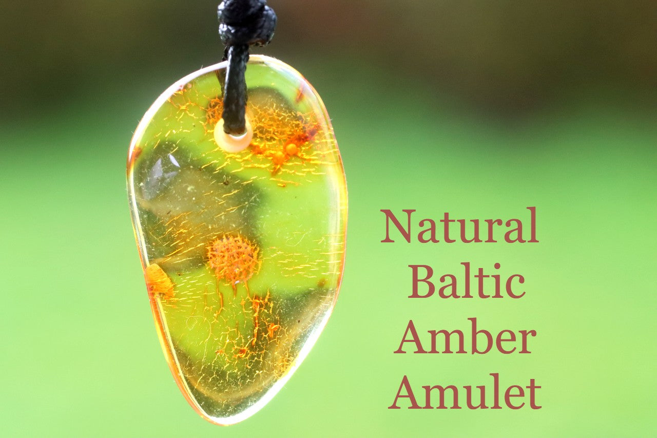 Natural Baltic Amber Amulet on a blurred green background with text.