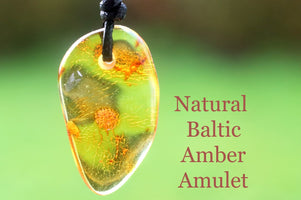 Natural Baltic Amber Amulet on a blurred green background with text.