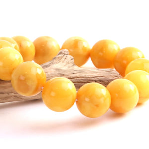 Yellow beaded bracelet on a white background