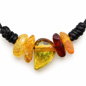 A black cord necklace featuring five polished amber stones in yellow, orange, and reddish-brown hues, displayed against a solid white background.
