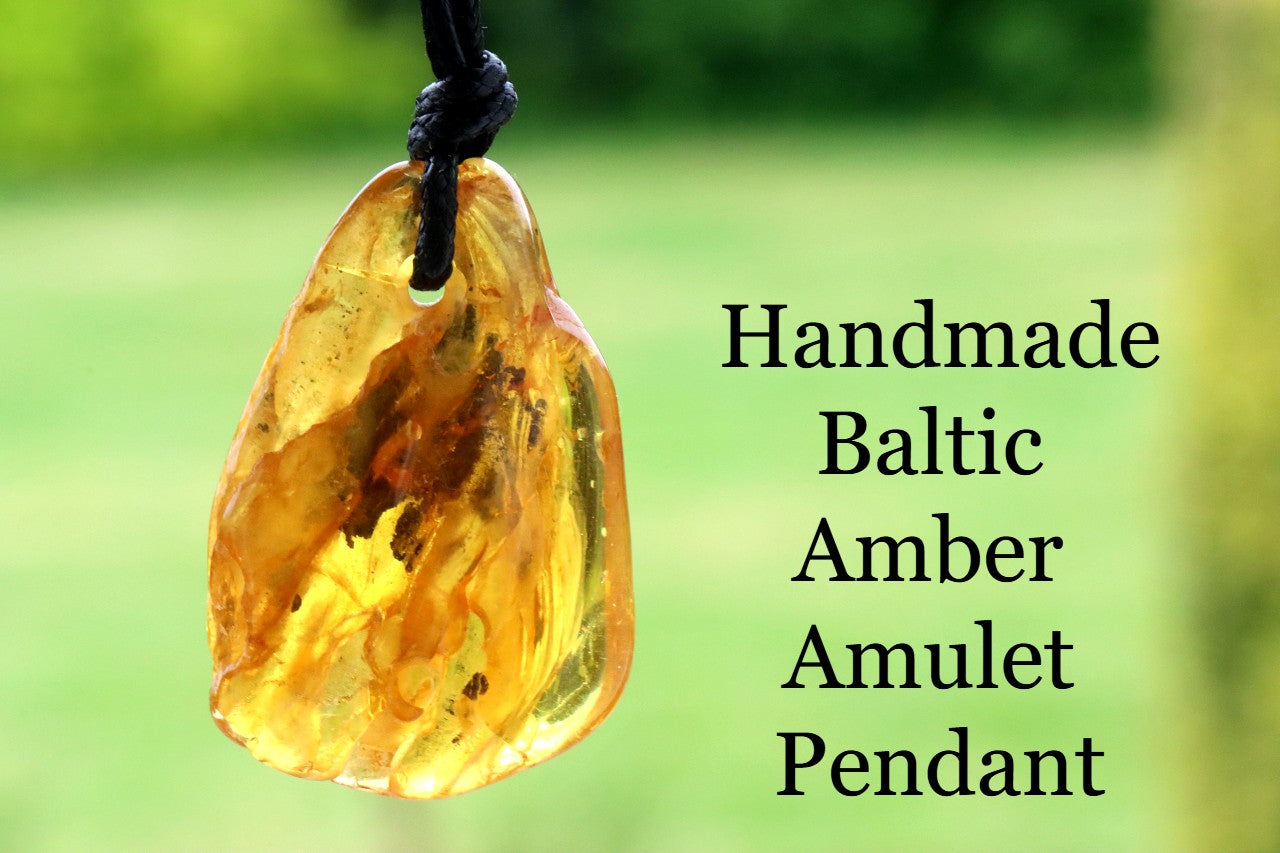 Baltic Amber Amulet Pendant with a blurred green background
