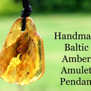 Baltic Amber Amulet Pendant with a blurred green background