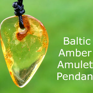 Baltic Amber Amulet Pendant on a blurred green background