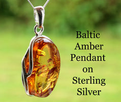 Baltic Amber Pendant on Sterling Silver with a blurred green background
