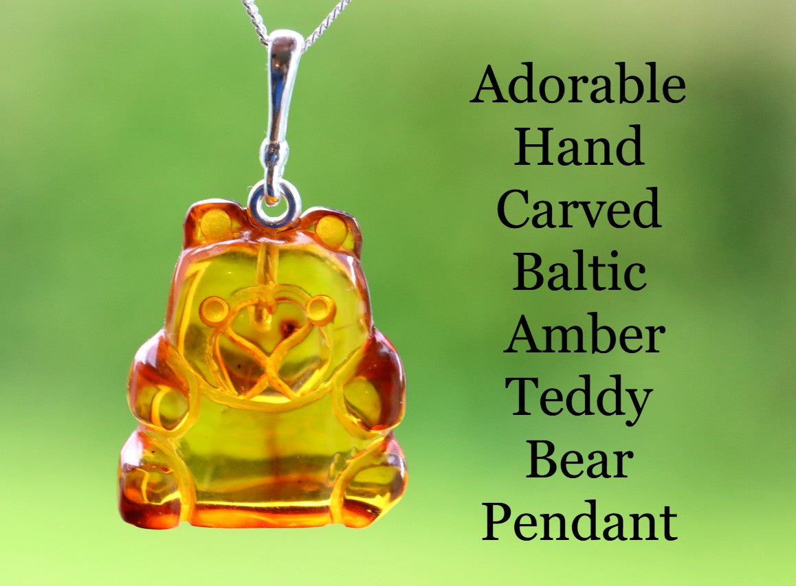 Hand-carved Baltic Amber Teddy Bear Pendant on a green background with text.
