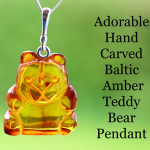 Hand-carved Baltic Amber Teddy Bear Pendant on a green background with text.