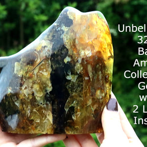 Baltic Amber Collector's Gem held by hands showing colour variations 