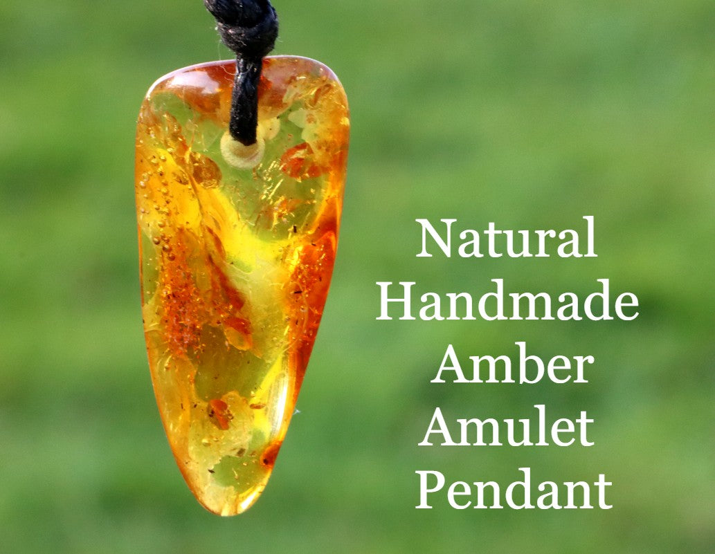 An amber amulet pendant with a rectangular shape, featuring a warm orange color, suspended from a black wax cord.