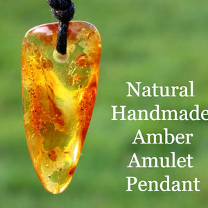 An amber amulet pendant with a rectangular shape, featuring a warm orange color, suspended from a black wax cord.