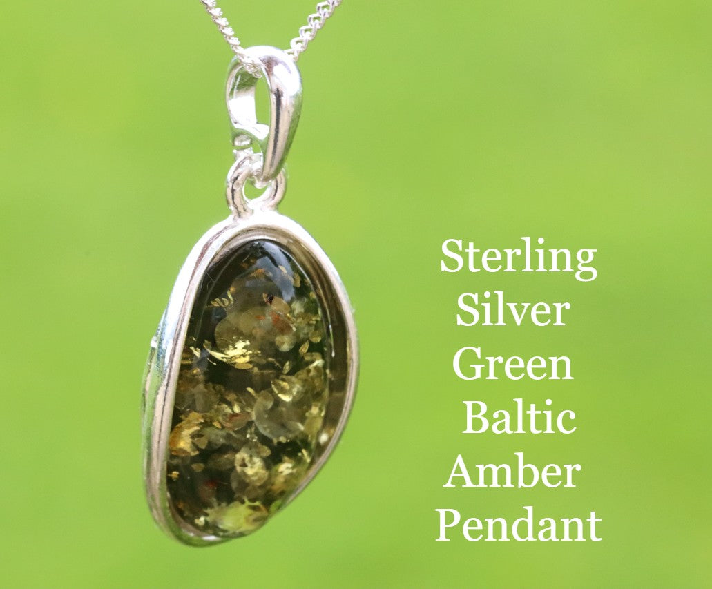Sterling silver green Baltic amber pendant on a green background
