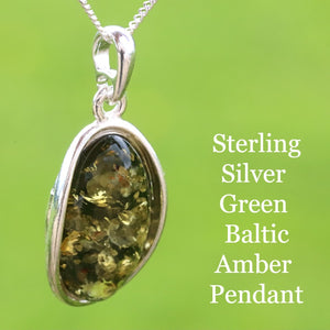 Sterling silver green Baltic amber pendant on a green background