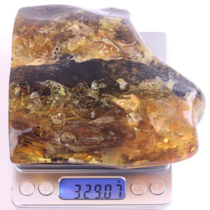 Large piece of amber on a digital scale with a white background