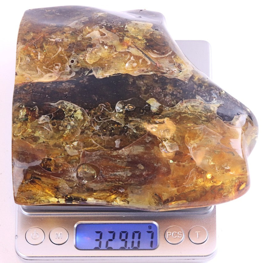 Large piece of amber on a digital scale with a white background
