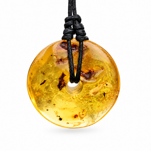 A round translucent amber pendant necklace with a black cord, featuring natural inclusions and bubbles inside the amber, set against a plain white background.