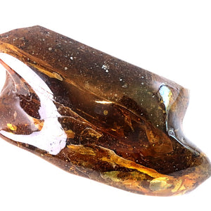 Large crystal with brownish tint on a white background