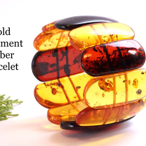 Large amber bangle on a white background with text 'Bold Statement Amber Bracelet'.