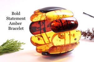 Large amber bangle on a white background with text 'Bold Statement Amber Bracelet'.