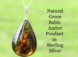 Teardrop-shaped green Baltic Amber pendant on a chain with a green background