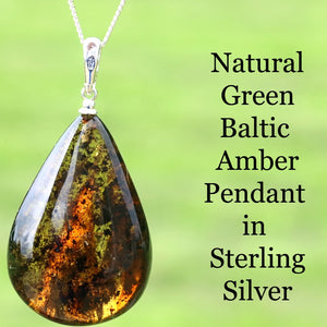 Teardrop-shaped green Baltic Amber pendant on a chain with a green background