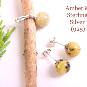 Amber and sterling silver jewelry set on a white background with text indicating material and purity.