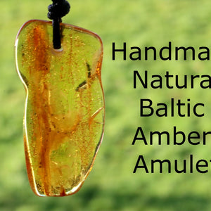 A hand-shaped amber amulet pendant with 'Handmade Natural Baltic Amber Amulet' text overlayed on a background of greenery.