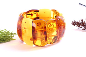 Amber bracelet with natural inclusions on a white background