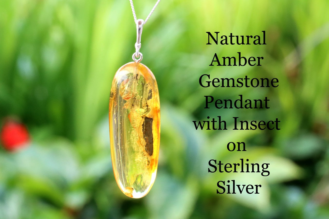 Silver Pendant Drop with Inclusion against green background