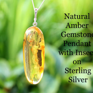Silver Pendant Drop with Inclusion against green background