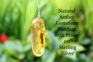 Silver Pendant Drop with Inclusion against green background