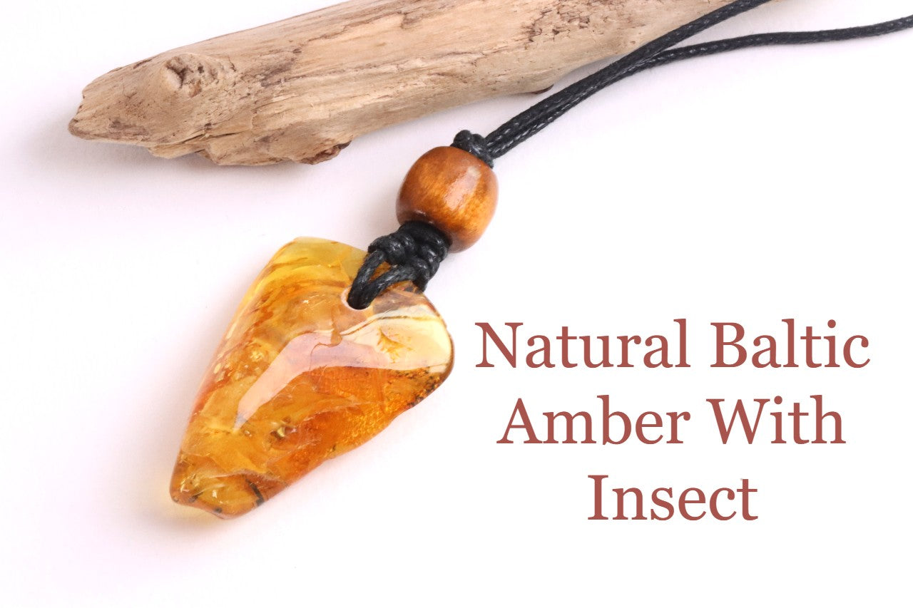 A unique Baltic amber amulet pendant featuring a fascinating insect inclusion