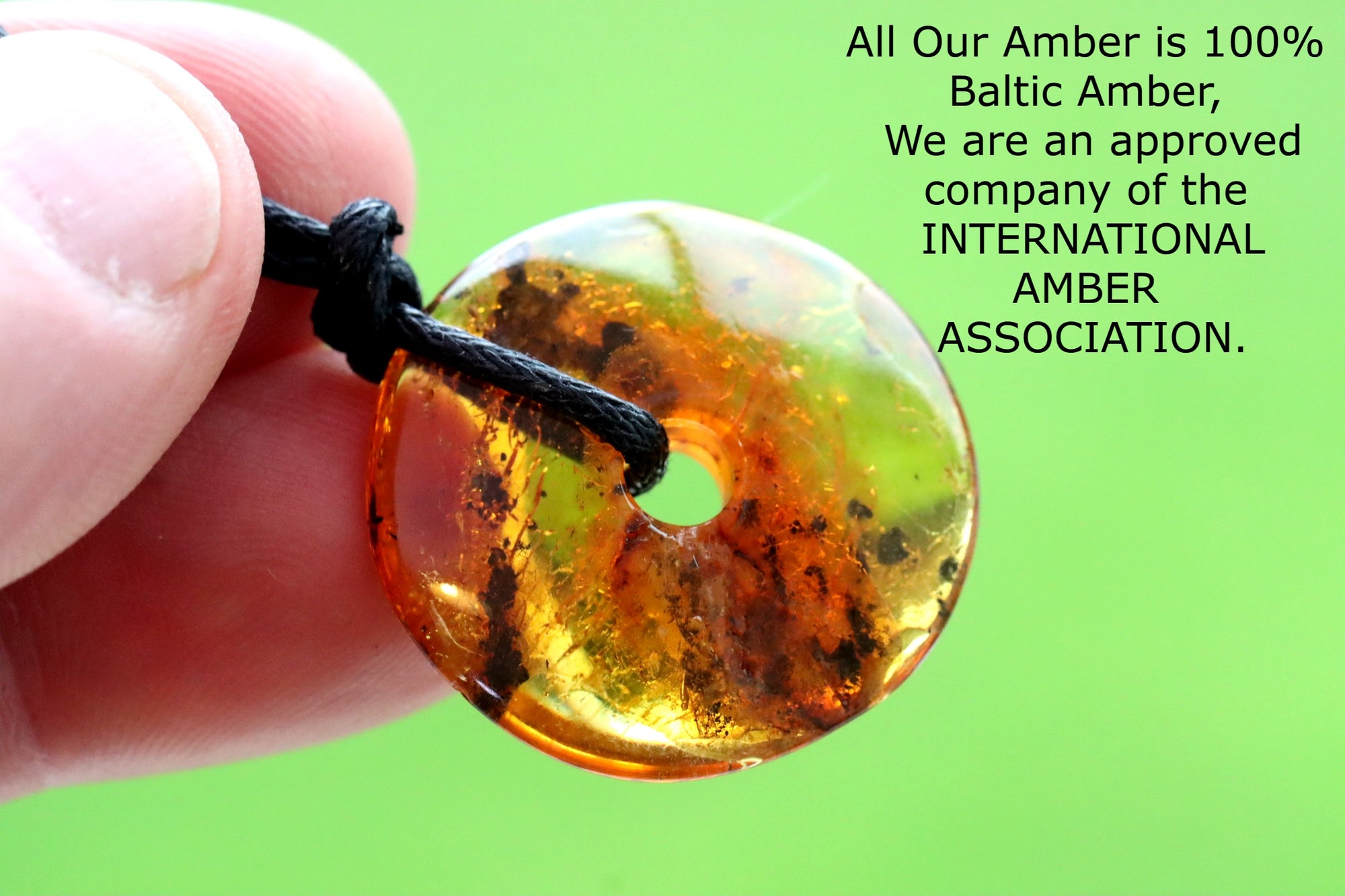 Polished Dainty Amber Donut Amulet on adjustable cord.
