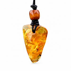 A raw amber pendant necklace with a polished, irregular teardrop-shaped piece of translucent amber and a small round amber bead on a black cord, shown against a plain white background.