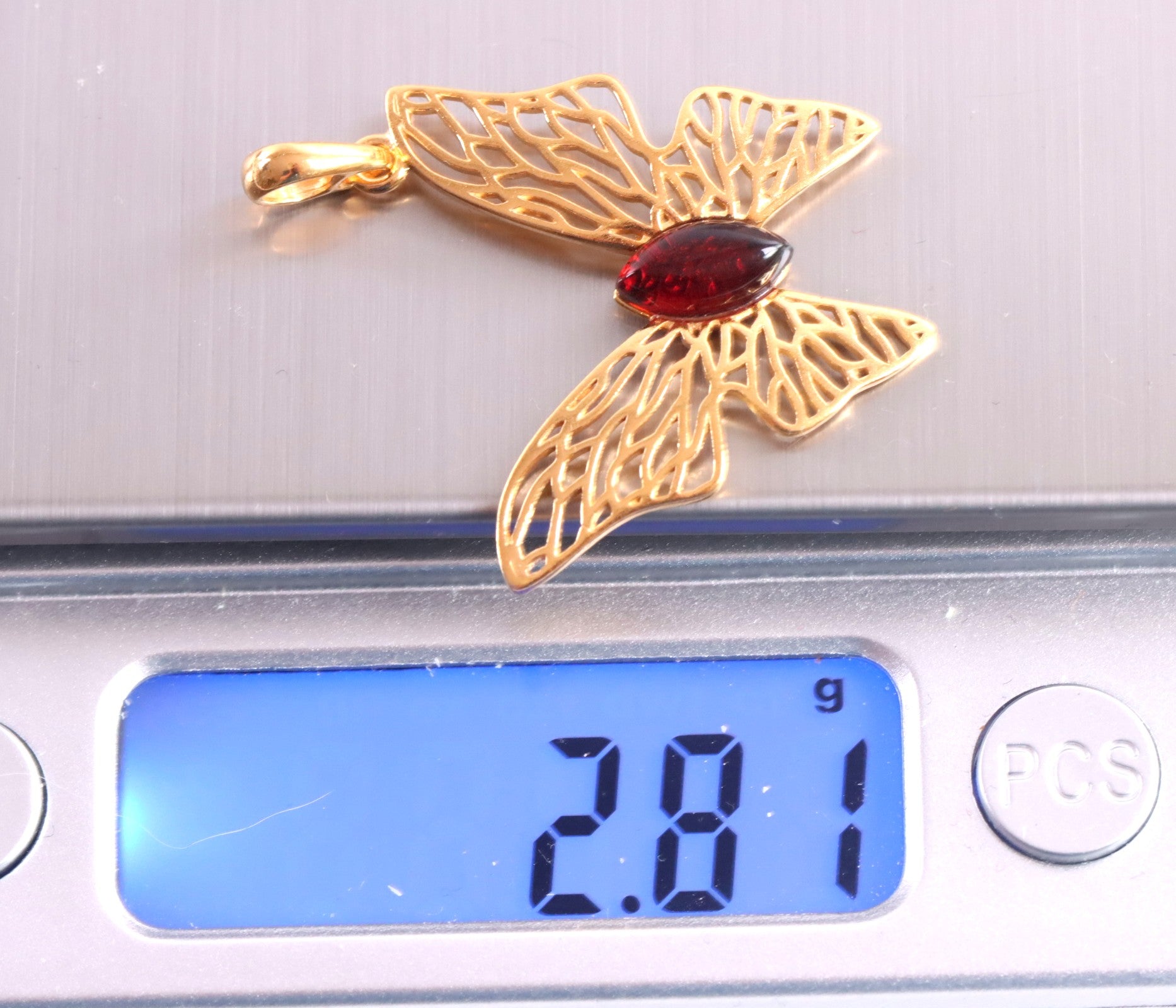Butterfly pendant on scale