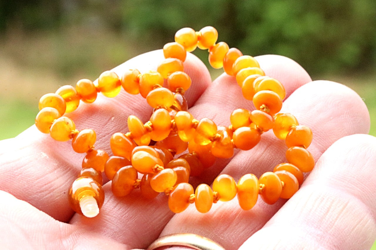 Amber necklace in the hand