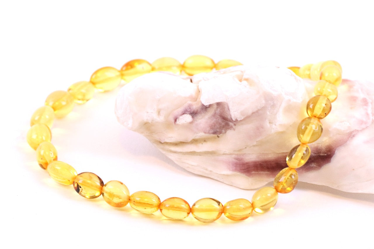 Amber Bead Anklet draped over oyster shell