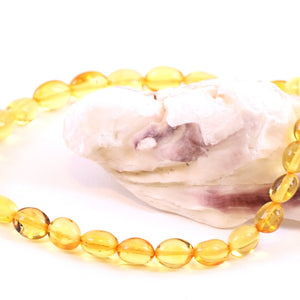 Amber Bead Anklet draped over oyster shell